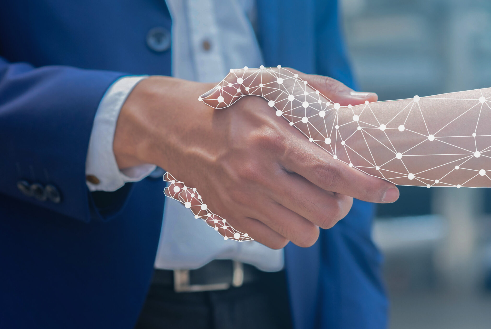 Close-up of a businessman shaking hands with an AI robot hologram.